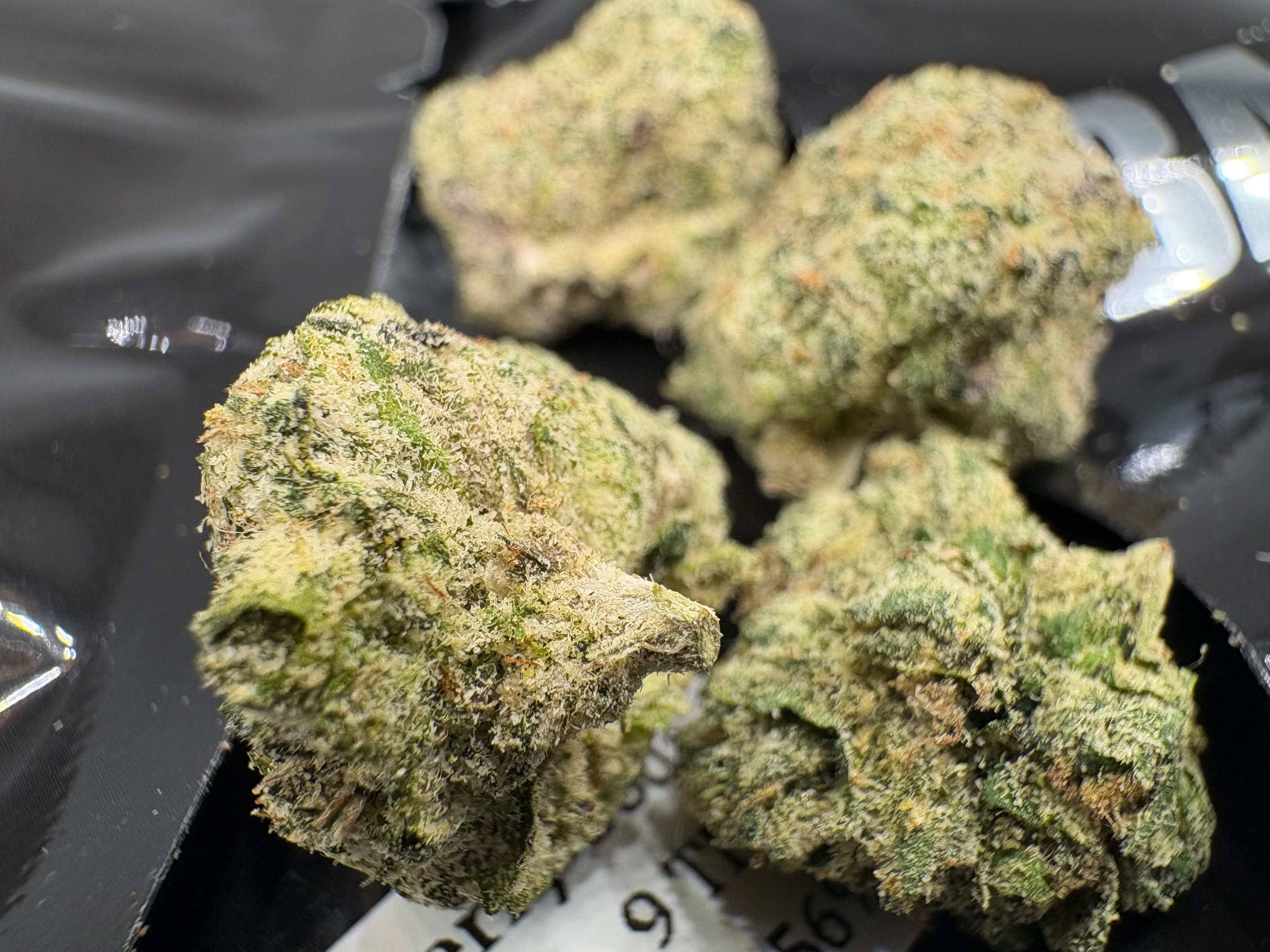 A collection of premium THCA flower buds and branded containers